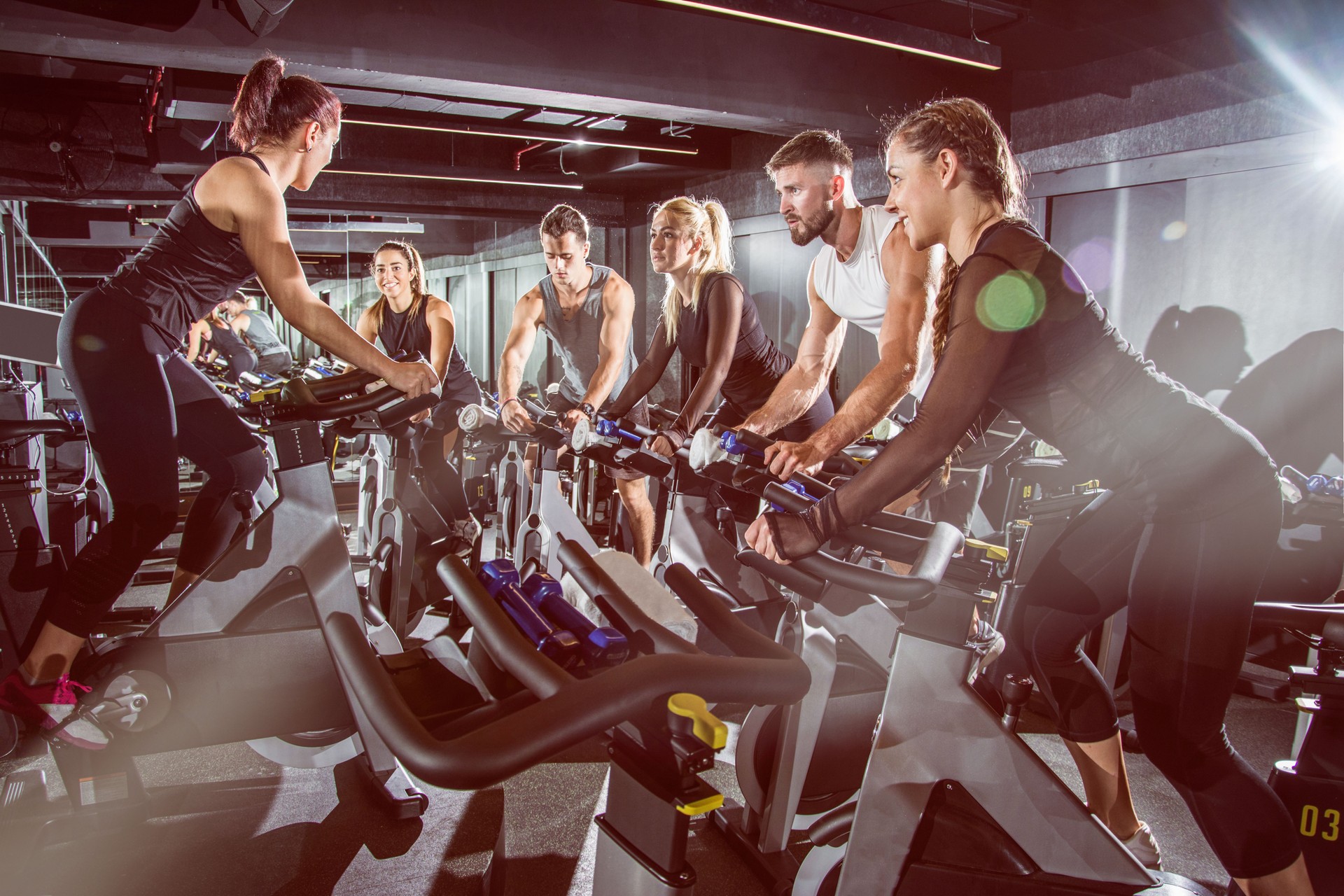 Fit people working out at exercising class in the gym.